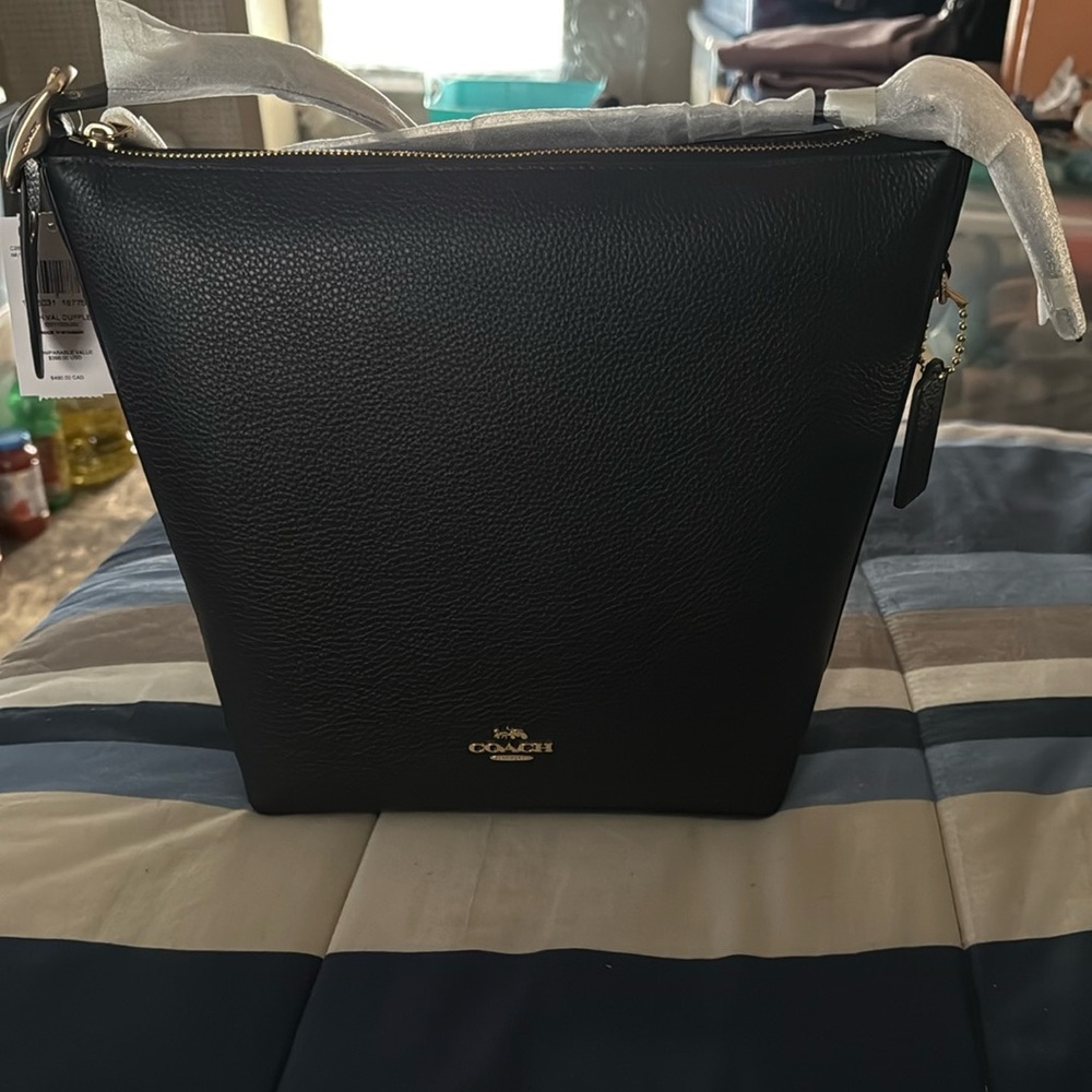 Brand new black hobo coach bag with tags on it